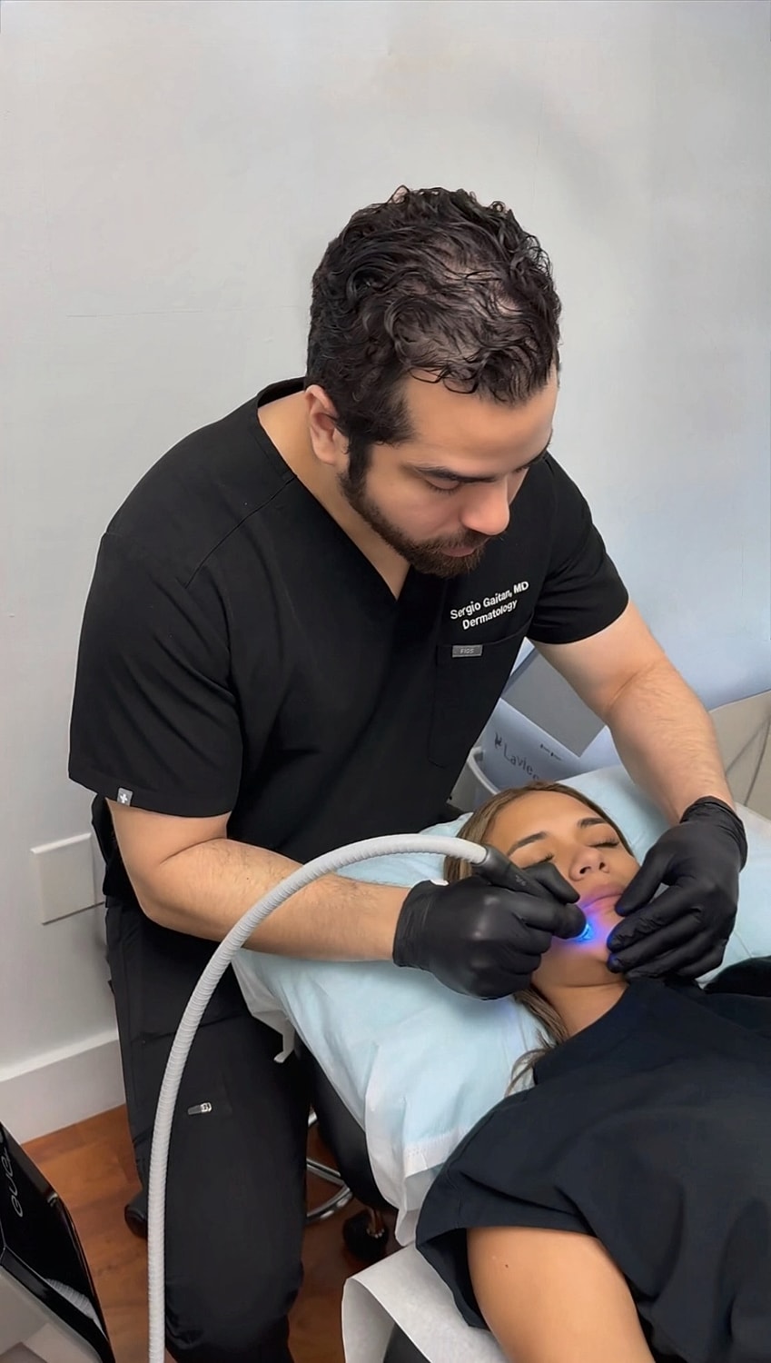 Dermatologist performing treatment on a patient.