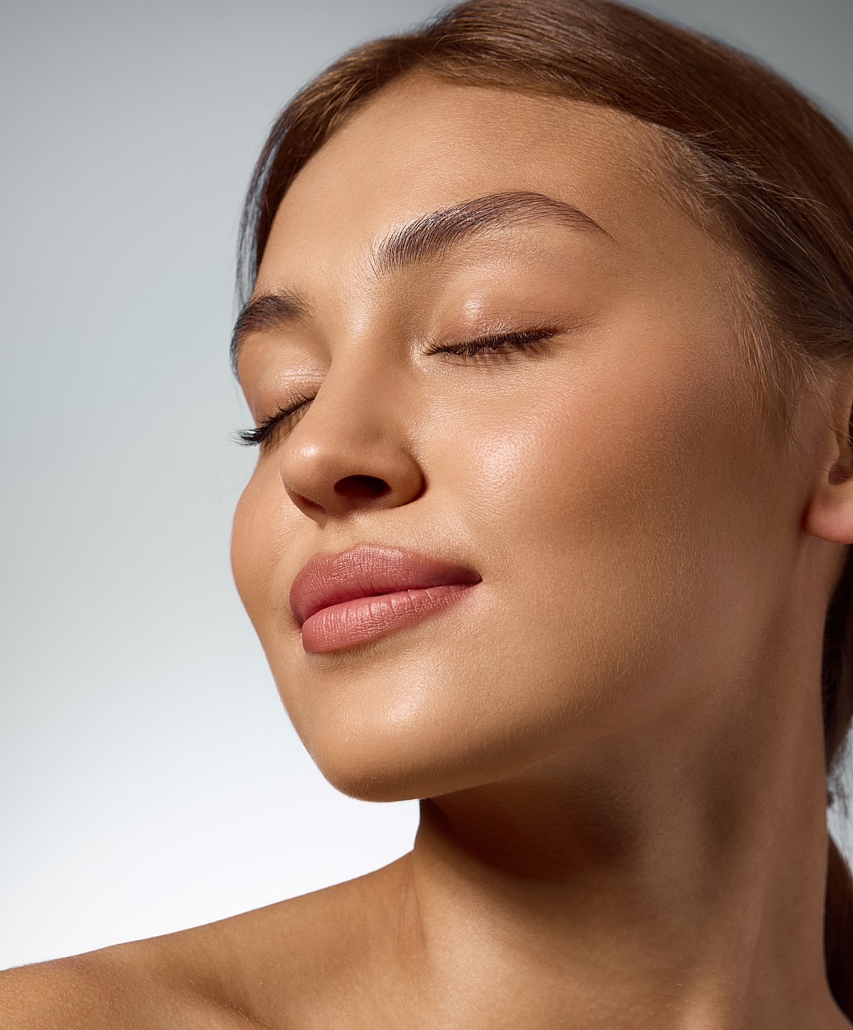 Close-up of serene woman with closed eyes.