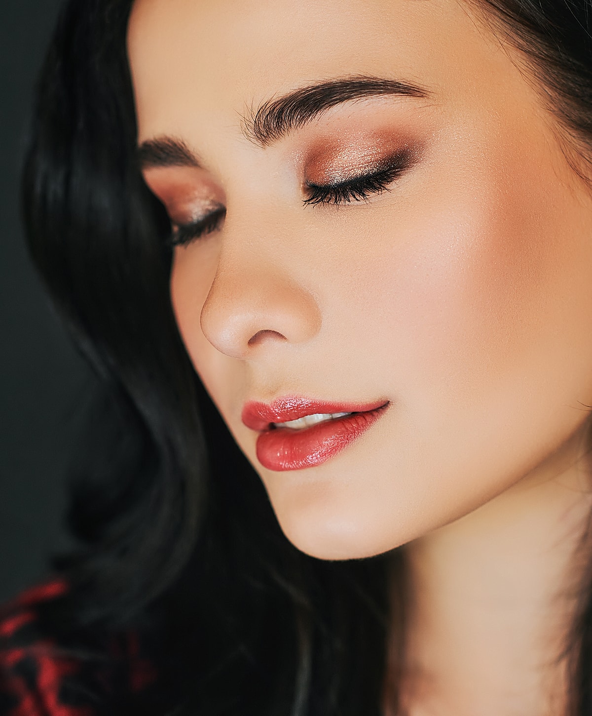 Close-up of a woman's serene, illuminated face.