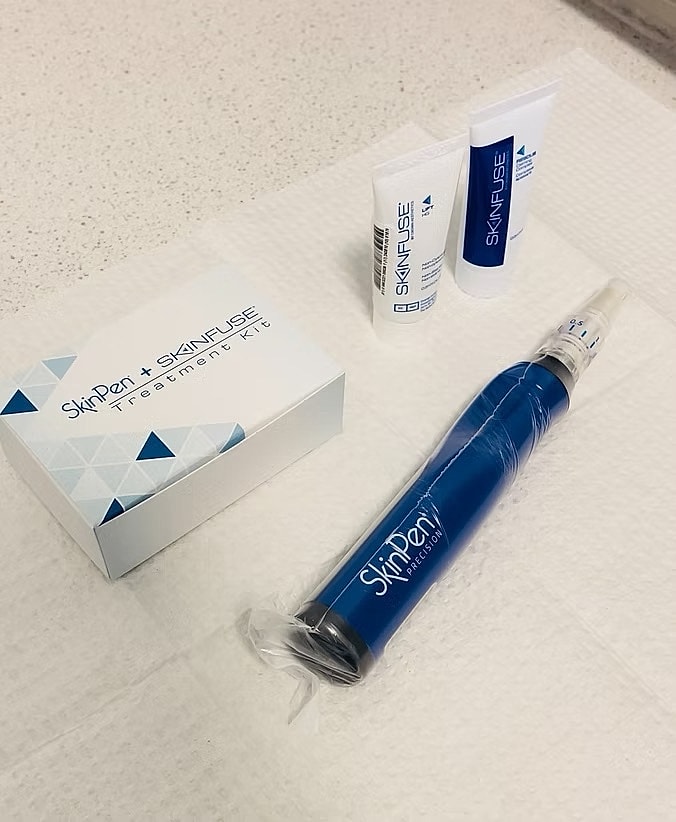Skin treatment kit with microneedling device.