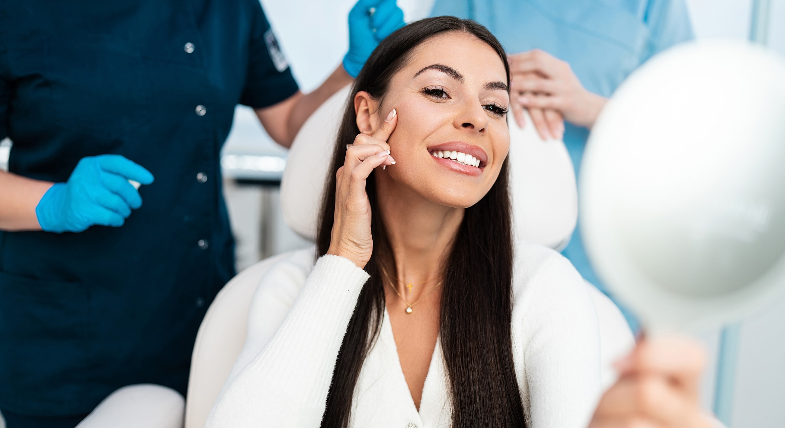 Woman smiling in a dental or cosmetic office.