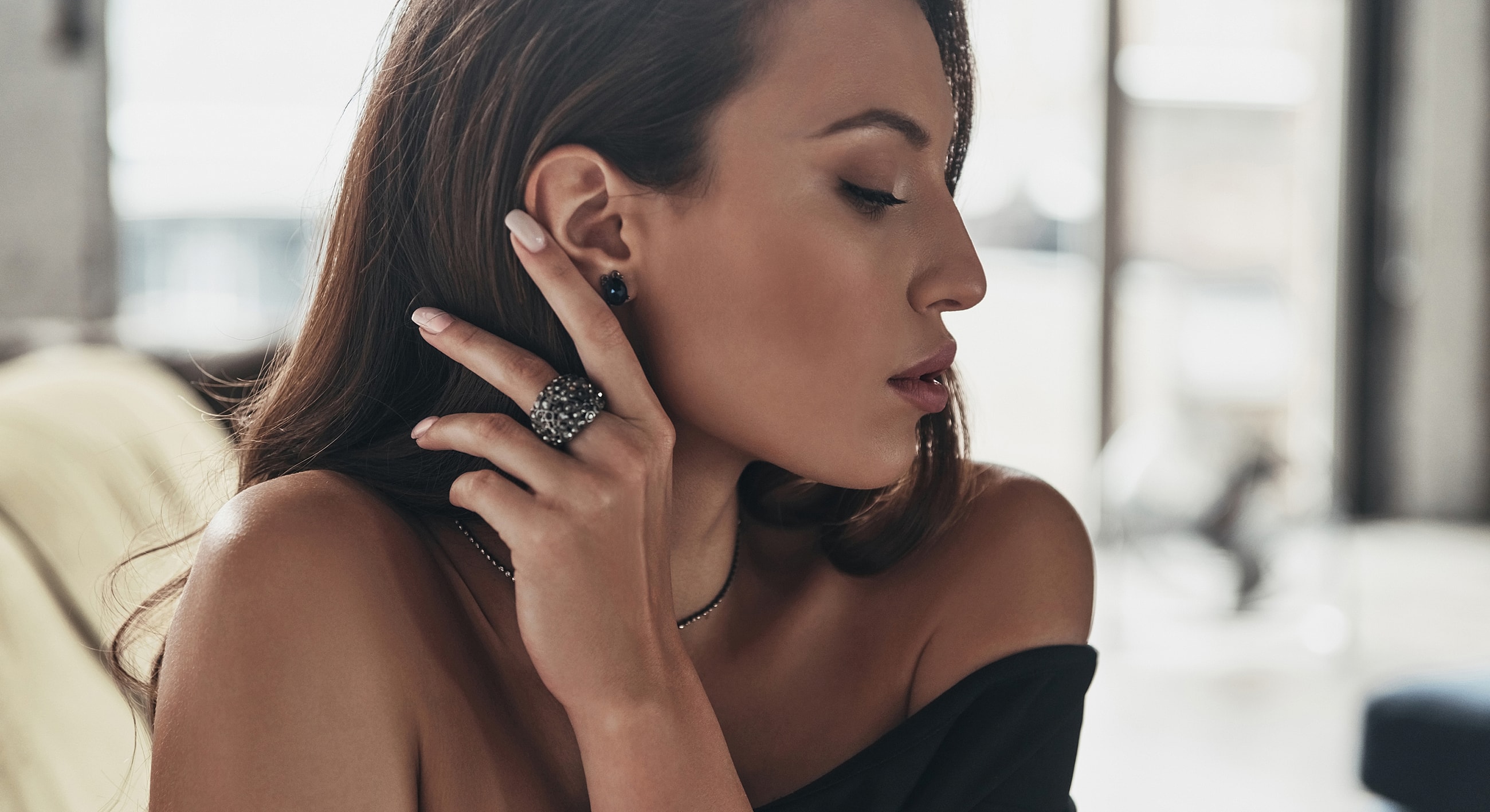 Woman wearing elegant jewelry, profile view.